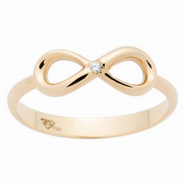 Bague infinity en or jaune sertie d'un diamant.