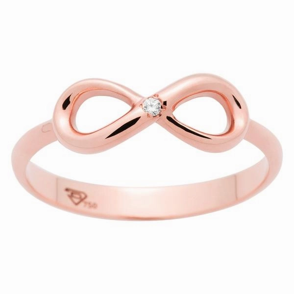 Bague infinity en or rose serti d'un diamant.