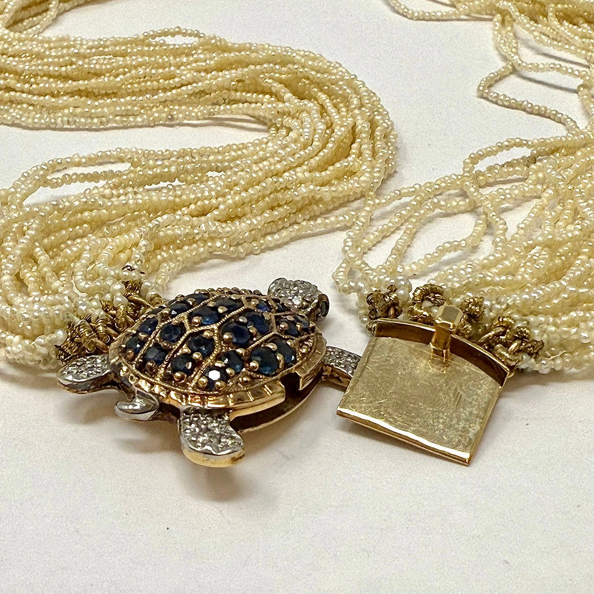 Multistrand Seed Pearl  Necklace with Tortoise Embellished Clasp